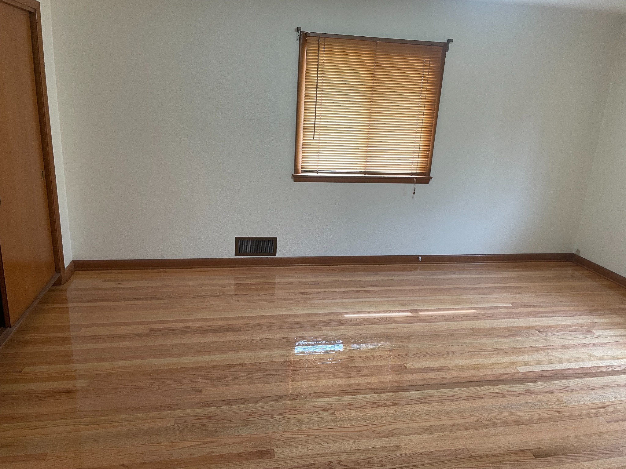Polished hardwood floor in bedroom